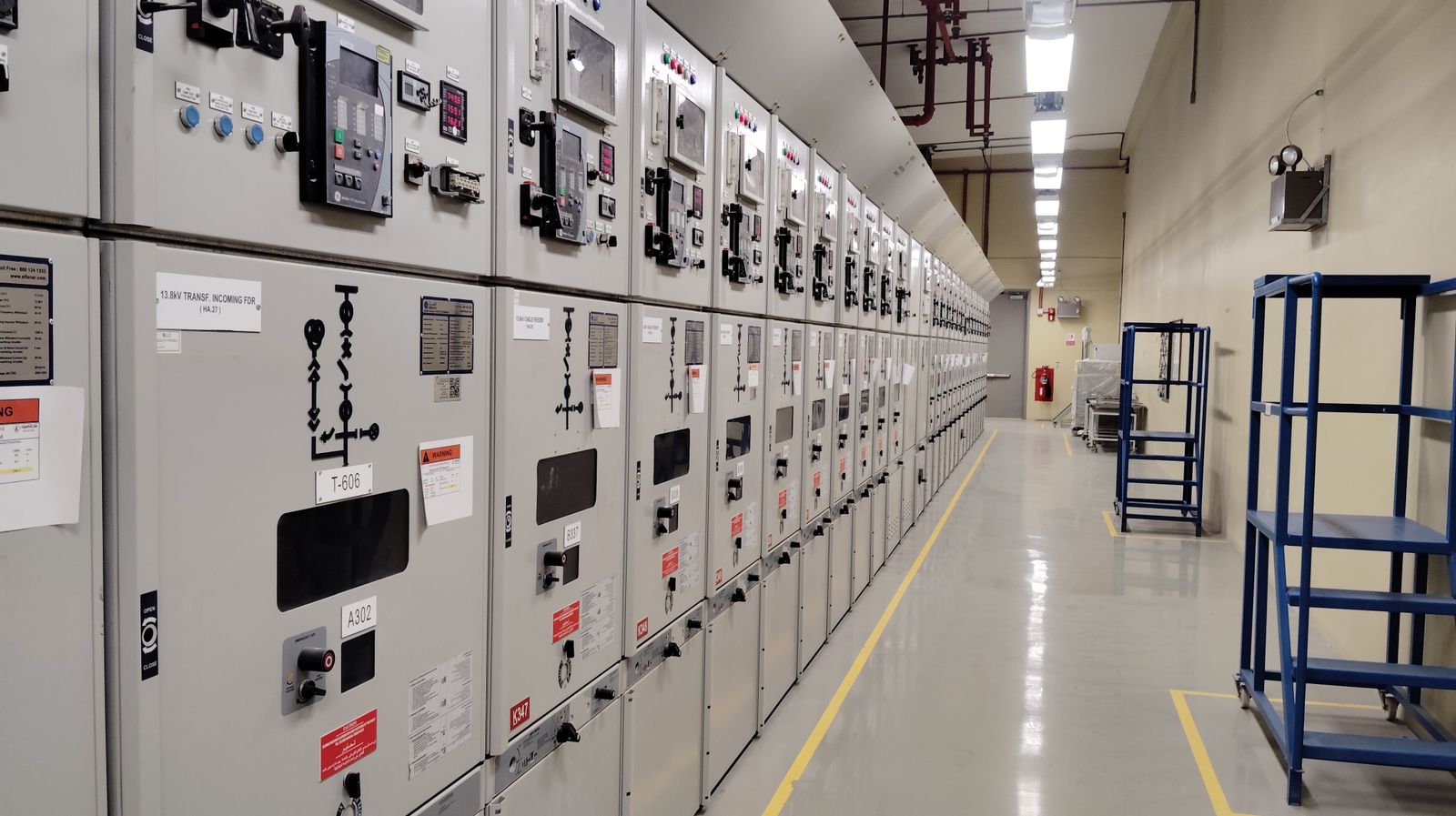 Lineup of low-tension switchgear panels in an industrial control room
